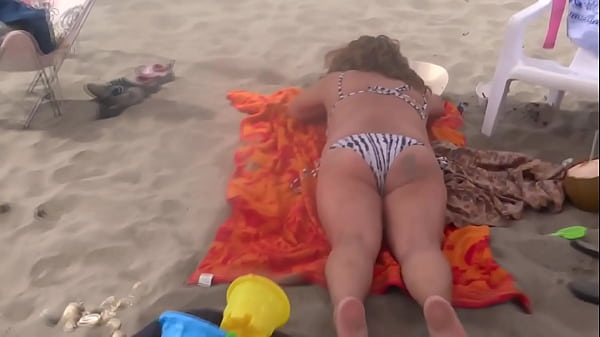 Stepmom shows off on the beach, very excited, and masturbates