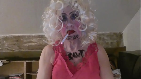CD Sissy Sarah Millward knows her ID, as indicated by what'_s written on her face and chest - '_fag slut'_ - as she smokes, wanks her clit, and stuffs a dildo up her nasty lady hole